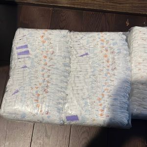 One unopened And one half bag of huggies little snugglers size 3